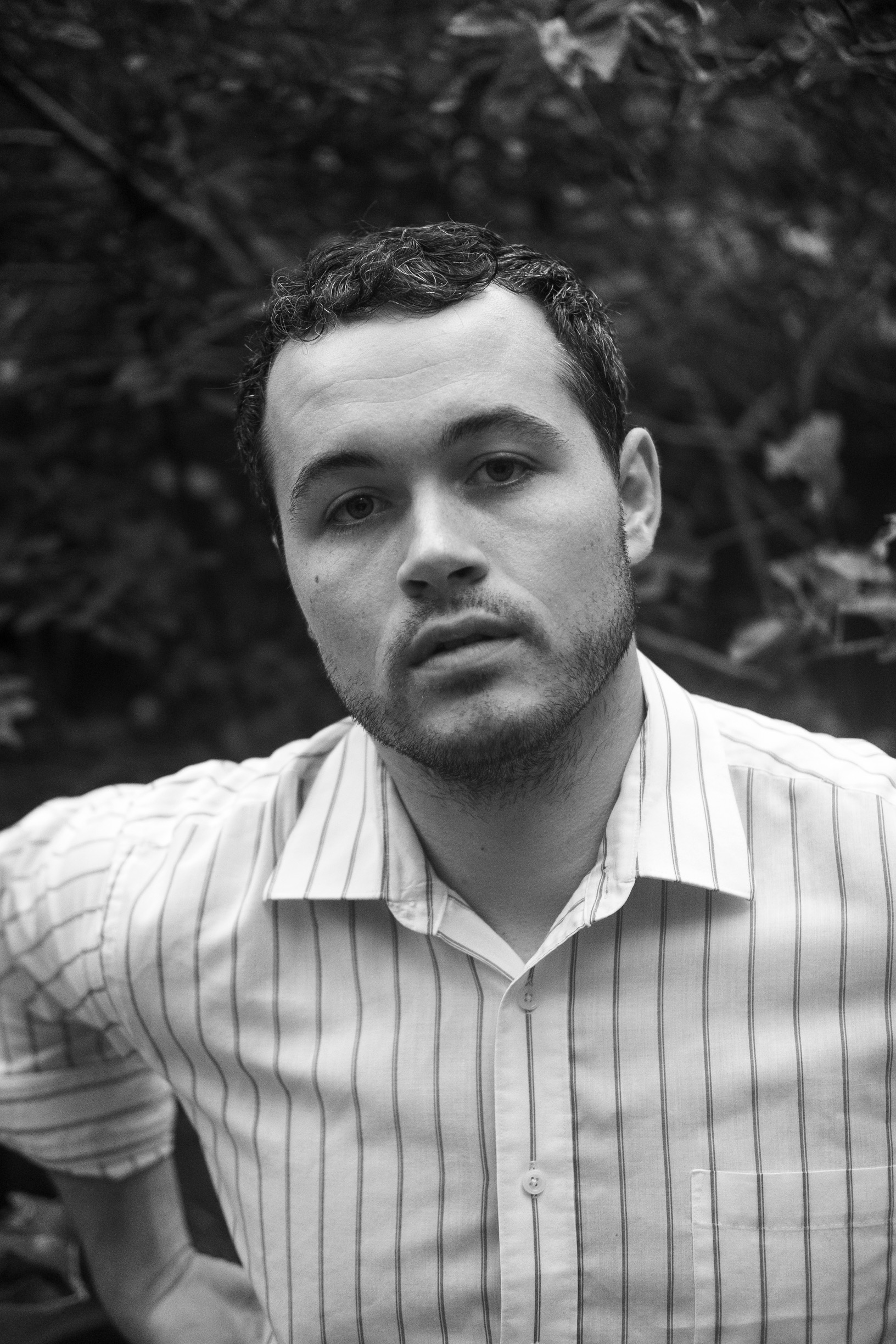 Portrait of Dane Ray in front of a tree canopy.